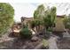 Professionally landscaped backyard with fire pit, mature trees, and cozy outdoor seating at 2320 E Allen St, Phoenix, AZ 85042
