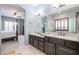 Bathroom with double vanity featuring stone countertops and a view to the main bedroom at 2320 E Allen St, Phoenix, AZ 85042