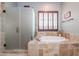 Relaxing bathroom with a soaking tub, walk-in shower and natural lighting at 2320 E Allen St, Phoenix, AZ 85042