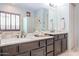 Bathroom with a double vanity, granite counters, and a separate glass enclosed shower at 2320 E Allen St, Phoenix, AZ 85042