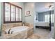 Bathroom features a soaking tub, and a view from the bathroom to the main bedroom at 2320 E Allen St, Phoenix, AZ 85042