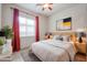 Bedroom with a modern design, featuring a ceiling fan and red curtains at 2320 E Allen St, Phoenix, AZ 85042