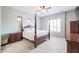 Comfortable bedroom features a four-poster bed, soft carpet, and bright natural light at 2320 E Allen St, Phoenix, AZ 85042