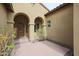 Covered entryway showcasing a wood door, arched columns, and neutral patio tile at 2320 E Allen St, Phoenix, AZ 85042
