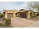 Charming single-story home featuring a terracotta tile roof, dual garages, and desert landscaping at 2320 E Allen St, Phoenix, AZ 85042