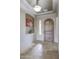 Inviting foyer with travertine floors, archways, and custom lighting at 2320 E Allen St, Phoenix, AZ 85042