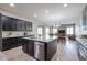Stylish kitchen featuring an island, stainless steel dishwasher, and dark cabinets at 2320 E Allen St, Phoenix, AZ 85042