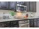 This kitchen has stainless steel appliances, granite countertops, and dark-stained cabinets at 2320 E Allen St, Phoenix, AZ 85042