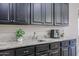 The kitchen features granite countertops, dark wood cabinets, and a stainless-steel sink at 2320 E Allen St, Phoenix, AZ 85042