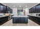 Expansive kitchen with large island, granite countertops, stainless steel appliances and dark cabinets at 2320 E Allen St, Phoenix, AZ 85042