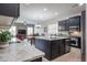 Spacious kitchen featuring granite countertops, large island, dark cabinets, and stainless steel appliances at 2320 E Allen St, Phoenix, AZ 85042