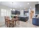 Open kitchen with dark wood cabinets, stainless steel appliances, granite countertops and chandelier lighting at 2320 E Allen St, Phoenix, AZ 85042