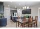 Open kitchen with granite countertops, dark wood cabinets, stainless steel appliances and wood dining table at 2320 E Allen St, Phoenix, AZ 85042