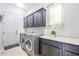 Laundry room features a front loading washer and dryer, cabinets, and counter space at 2320 E Allen St, Phoenix, AZ 85042