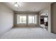 Spacious living room with large windows offering natural light and a smooth carpet at 2320 E Allen St, Phoenix, AZ 85042