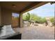 Covered outdoor kitchen with built-in grill, stone pavers, seating, and firepit area at 2320 E Allen St, Phoenix, AZ 85042