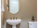 Powder room features a pedestal sink, mirror, and toilet at 2320 E Allen St, Phoenix, AZ 85042