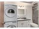 Bathroom features a stacked washer/dryer with white vanity and tiled shower in neutral tones at 2442 E University Dr # 6, Mesa, AZ 85213