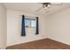 Bright bedroom featuring hardwood floors, a ceiling fan and a window at 2442 E University Dr # 6, Mesa, AZ 85213