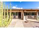 Inviting front porch featuring desert landscaping, seating and secure front door entry at 2442 E University Dr # 6, Mesa, AZ 85213