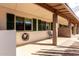 View of the home's covered front porch with seating area; great curb appeal at 2442 E University Dr # 6, Mesa, AZ 85213