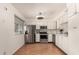 Bright kitchen featuring stainless steel appliances, white cabinetry, and a window with blinds at 2442 E University Dr # 6, Mesa, AZ 85213