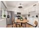 Bright kitchen features stainless steel appliances, white cabinetry, and a round table at 2442 E University Dr # 6, Mesa, AZ 85213