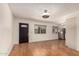 Empty living room features wood-look flooring, a dark front door and two windows at 2442 E University Dr # 6, Mesa, AZ 85213