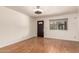 Empty living room with wood-look flooring, a dark front door and window with blinds at 2442 E University Dr # 6, Mesa, AZ 85213