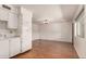 Open living room with wood-look floors, natural light and a view of the kitchen and front door at 2442 E University Dr # 6, Mesa, AZ 85213