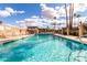 Community pool with clear water, surrounding lounge seating, and a vibrant sky backdrop at 2442 E University Dr # 6, Mesa, AZ 85213