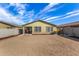 Back exterior featuring a covered patio, xeriscaped landscaping, and a concrete block wall at 24531 W Cocopah St, Buckeye, AZ 85326
