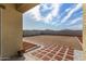 A partially xeriscaped backyard shows a tiled walkway, stone landscaping, and a concrete block wall at 24531 W Cocopah St, Buckeye, AZ 85326