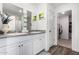 Elegant bathroom features a dual sink vanity with granite counters, white cabinets, and a walk-in closet at 24531 W Cocopah St, Buckeye, AZ 85326
