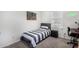 Clean bedroom with a single bed, dark hardwood desk, and small nightstand at 24531 W Cocopah St, Buckeye, AZ 85326