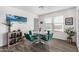Cozy dining area with a round table, retro-style chairs, and bright natural lighting at 24531 W Cocopah St, Buckeye, AZ 85326