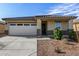 Charming single-story home featuring a two-car garage, desert landscaping and a tile roof at 24531 W Cocopah St, Buckeye, AZ 85326