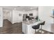 Modern kitchen with stainless steel appliances, a granite countertop bar, and sleek black barstools at 24531 W Cocopah St, Buckeye, AZ 85326