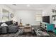 Modern living room featuring a comfortable gray couch, stylish rug and a colorful entertainment center at 24531 W Cocopah St, Buckeye, AZ 85326