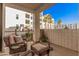 Cozy balcony featuring comfortable seating and views of the community and palm trees at 2511 W Queen Creek Rd # 163, Chandler, AZ 85248