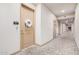 Inviting hallway featuring neutral walls, patterned carpet, and a decorative wreath on a suite door at 2511 W Queen Creek Rd # 163, Chandler, AZ 85248