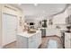 Bright kitchen features a center island, white cabinets, and an open concept design at 2511 W Queen Creek Rd # 163, Chandler, AZ 85248