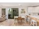 Bright kitchen with stainless steel appliances, island, barstool seating, and sliding doors to the patio at 2511 W Queen Creek Rd # 163, Chandler, AZ 85248