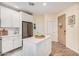 Bright kitchen boasts a center island, stainless steel appliances, and white cabinetry at 2511 W Queen Creek Rd # 163, Chandler, AZ 85248
