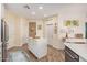 Bright kitchen includes a central island, white cabinets, and access to a hallway at 2511 W Queen Creek Rd # 163, Chandler, AZ 85248