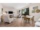 Open-concept living space features tile flooring, neutral walls, access to a balcony, and natural lighting at 2511 W Queen Creek Rd # 163, Chandler, AZ 85248
