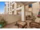 View of the patio with cushioned seating, neutral walls, and exposed aggregate flooring at 2511 W Queen Creek Rd # 163, Chandler, AZ 85248