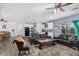 Open-concept living area featuring leather sofas, modern decor, and seamless flow to the kitchen at 2530 N 198Th Ave, Buckeye, AZ 85396