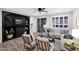 Inviting living room with a black entertainment center, a large window with shutters and plush furniture for relaxation at 2693 E Lodgepole Dr, Gilbert, AZ 85298