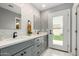 Stylish bathroom featuring double sinks, modern faucets, and subway tile at 2701 E Lockwood St, Mesa, AZ 85213